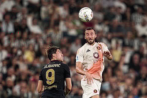 Serie A 2024-25 Juventus vs Roma: Roma's Bryan Cristante jumps for the ball with Juventus' Dusan Vlahovic